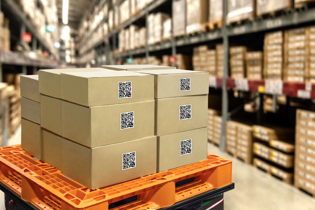 Boxes on a platform in a warehouse with full shelves around it. 
Overstocking will reduce working capital and take up space needed for in-demand stock. 