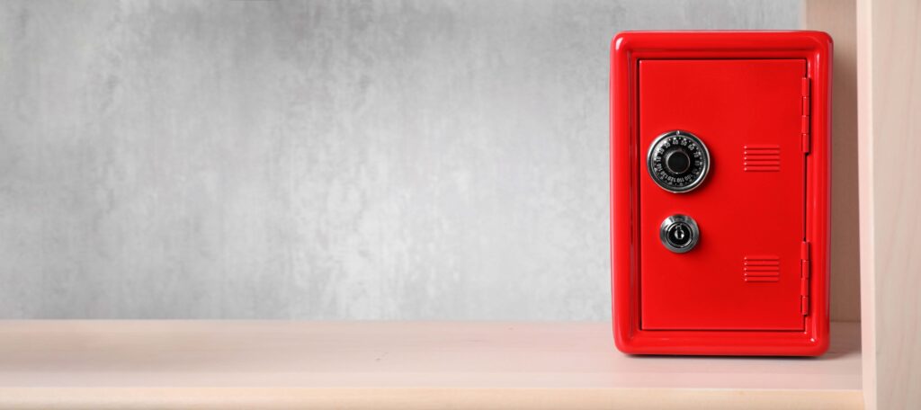 Red steel safe with mechanical combination lock on shelf, the secret to improving stock availability without increasing inventory