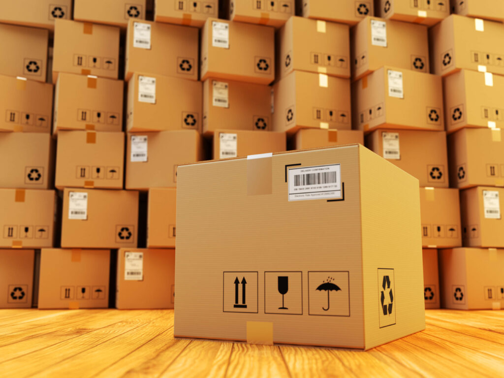 cardboard box and stack of parcels behind it on wooden floor in a warehouse how to manage excess stock