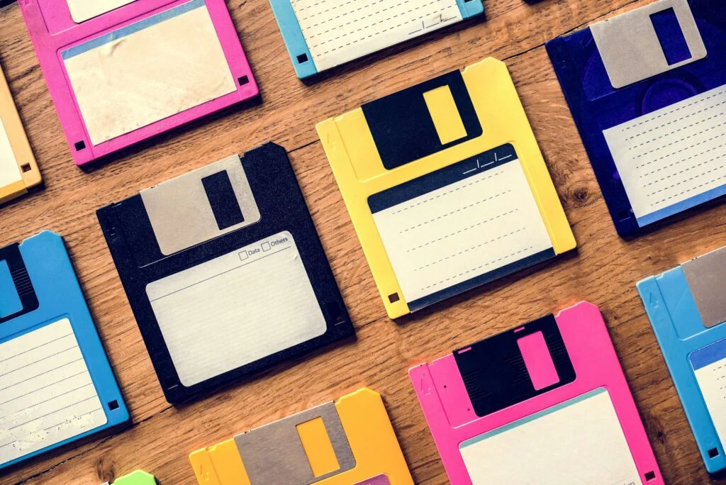 Different coloured floppy disks on a tables
