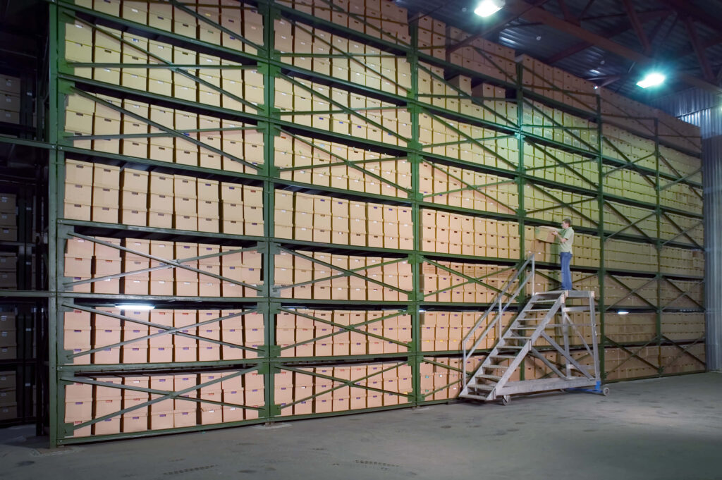 Warehouse shelves full of boxes to show low stock turnover