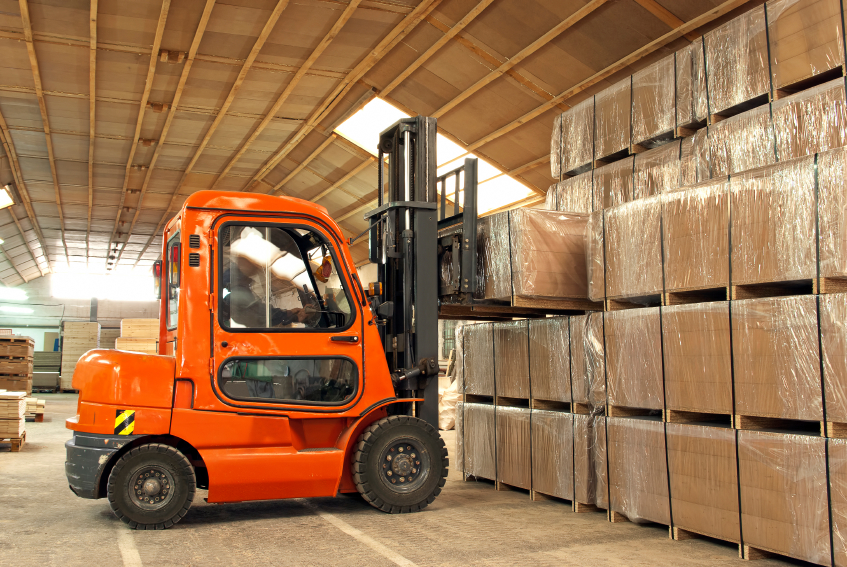 Forklift in a warehouse moving boxes