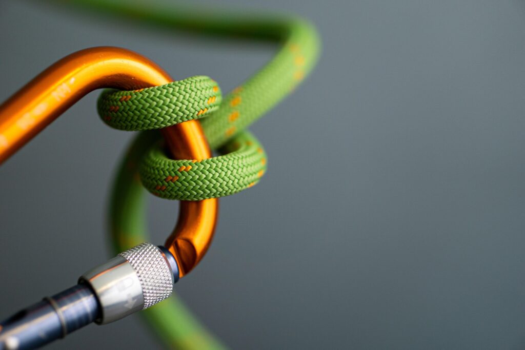 green rope wrapped around orange carabiner Leverbetrouwbaarheid in veranderende tijden