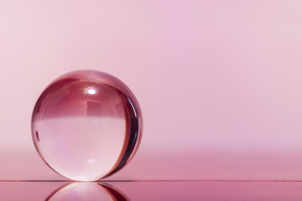 A crystal ball on a pale pink background to show demand forecast accuracy