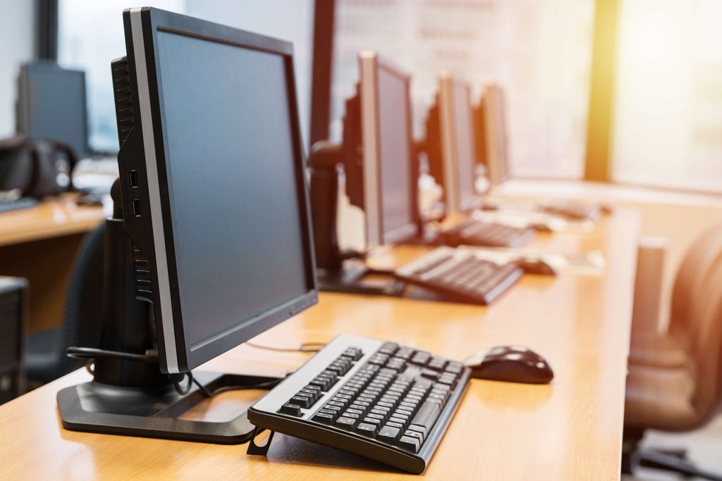 Computers in a row on a desk