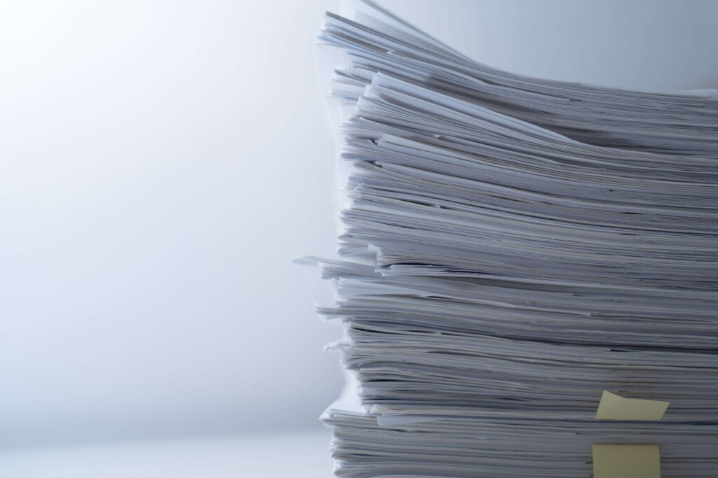 Paper stack on a table 
Supply chain digitisation is the process of making existing data and processes digital.