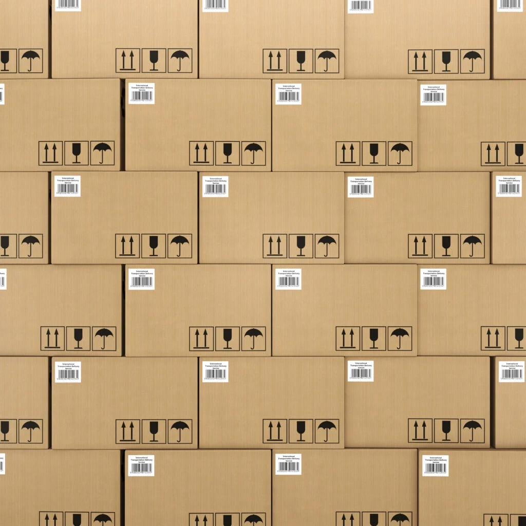 Brown boxes with small white labels in the top left corner all stacked on top of each other so you can only see boxes safety stock why safety stock is important