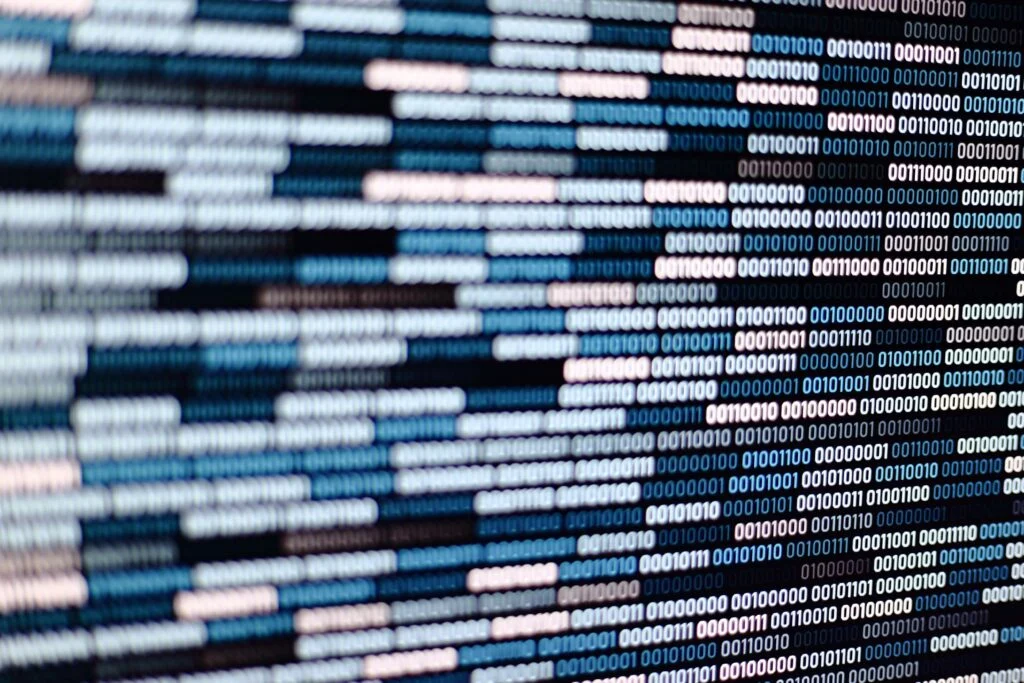 lines of binary data on a screen in different shades of blue and white
