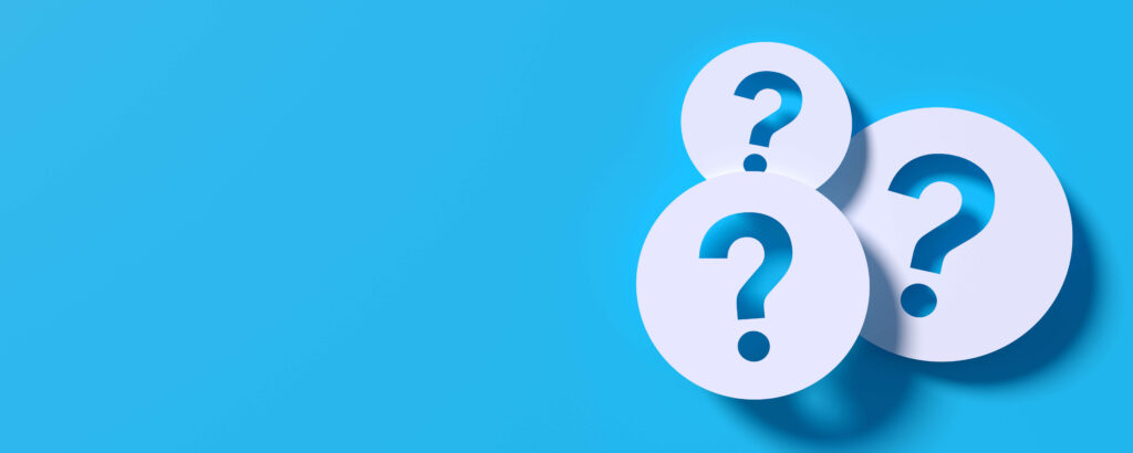 A blue background with three white circles on the right-hand side of slightly different sizes with cut-out question marks showing the blue background