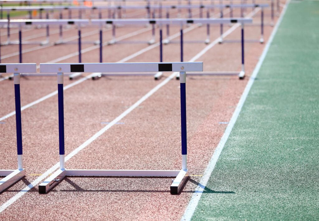 Overcoming inventory management challenges close up of the outside lanes of a running track with hurdles set out