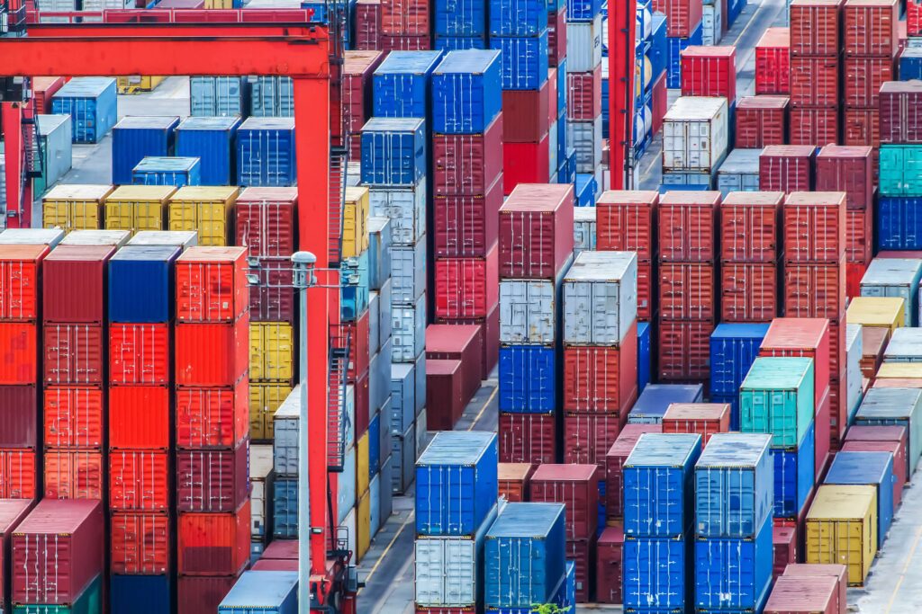 Shipping containers stacked up in a port red sea supply chain disruption shipping container shortages