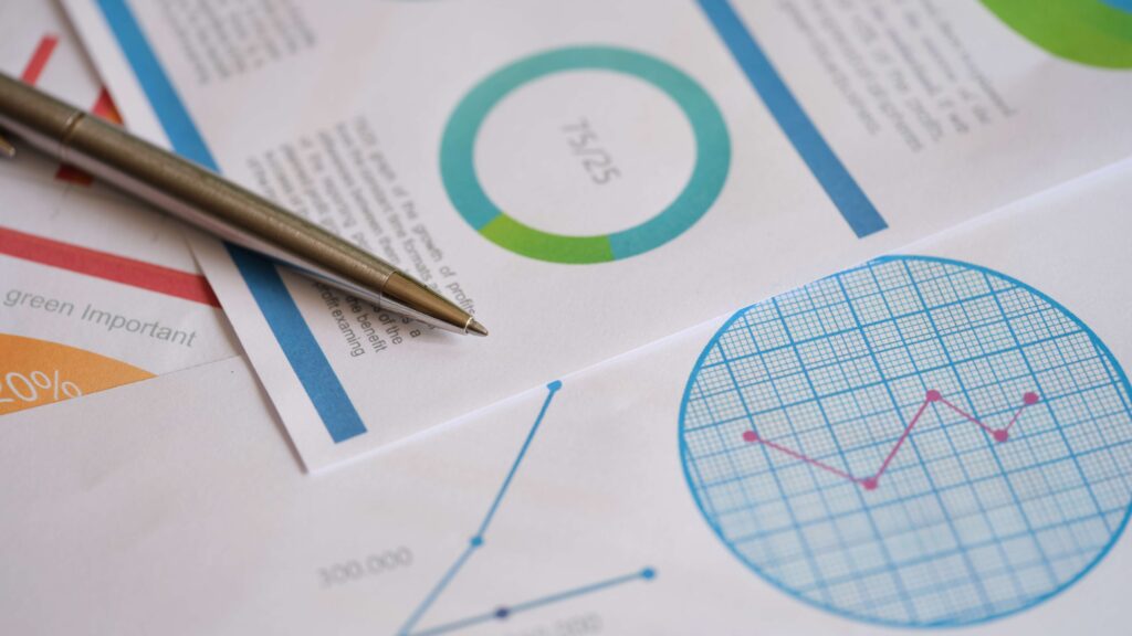 Print outs of paper charts on a table with a pen demand forecasting methods quantitative forecasting qualitative forecasting