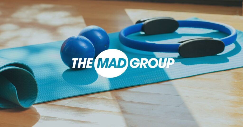 Mad Group logo over background image
