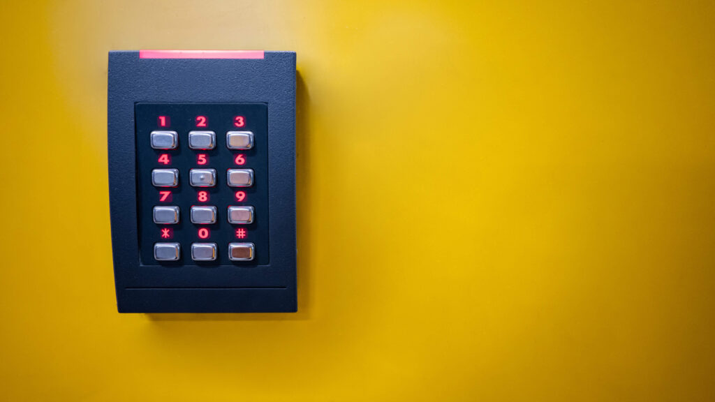 Key pad on a yellow wall information security