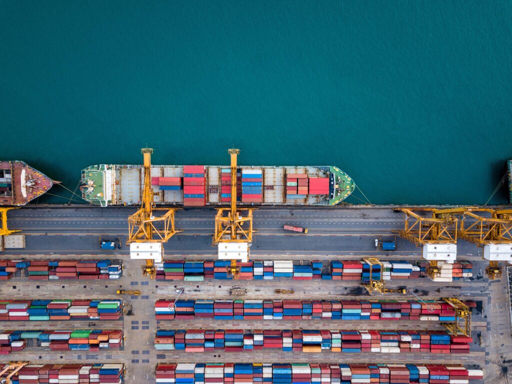 Overhead view of a cargo ship being loaded with shipping containers in a port.
As businesses enhance efficiency, reduce costs, and minimise supply chain disruption, choosing the right supplier location strategy is essential. Nearshoring, friendshoring, multishoring, and reshoring each offer distinct advantages and potential drawbacks.
