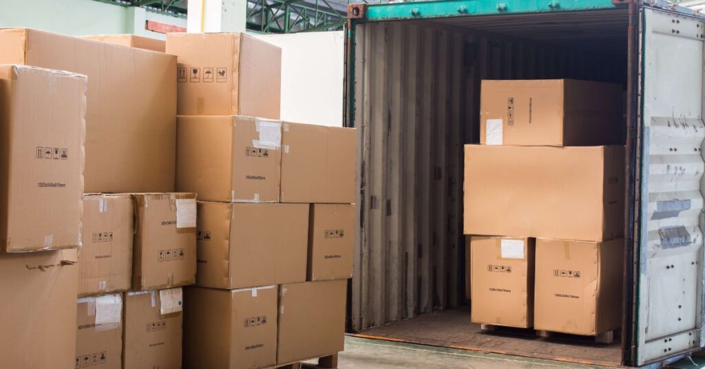 kartonger staplas vid en container