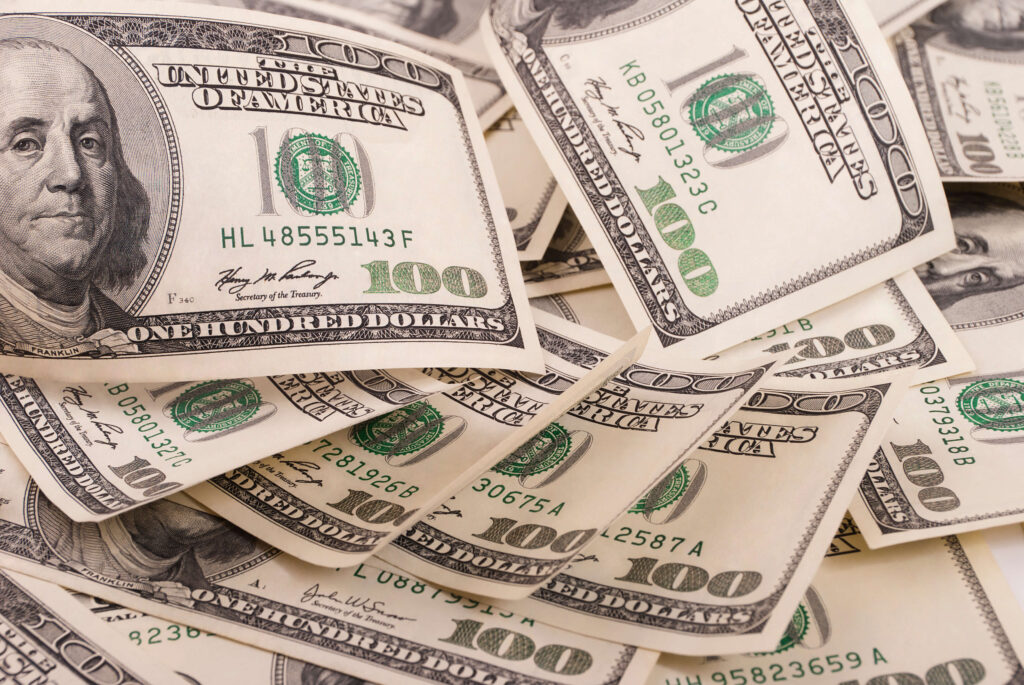 100 dollar bills
Rising tariffs significantly impact businesses and customers, as the additional costs of importing or exporting goods must be factored into the overall cost of the product. This leaves a decision for businesses – do they absorb the extra costs or pass them on to the customer?
