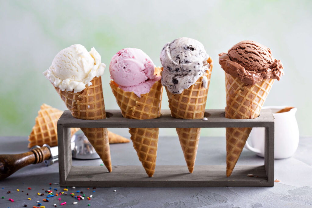 Four different flavoured ice creams in waffle cones in a stand on a counter.

Having examined the factors and impacts of bullwhip effects, let’s use the classic ice cream example to illustrate the bullwhip effect in supply chain operations.